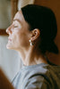 Side view of Aubergine Astrid earring with freshwater pearl – bold sculptural jewelry design by ANNE MANNS
